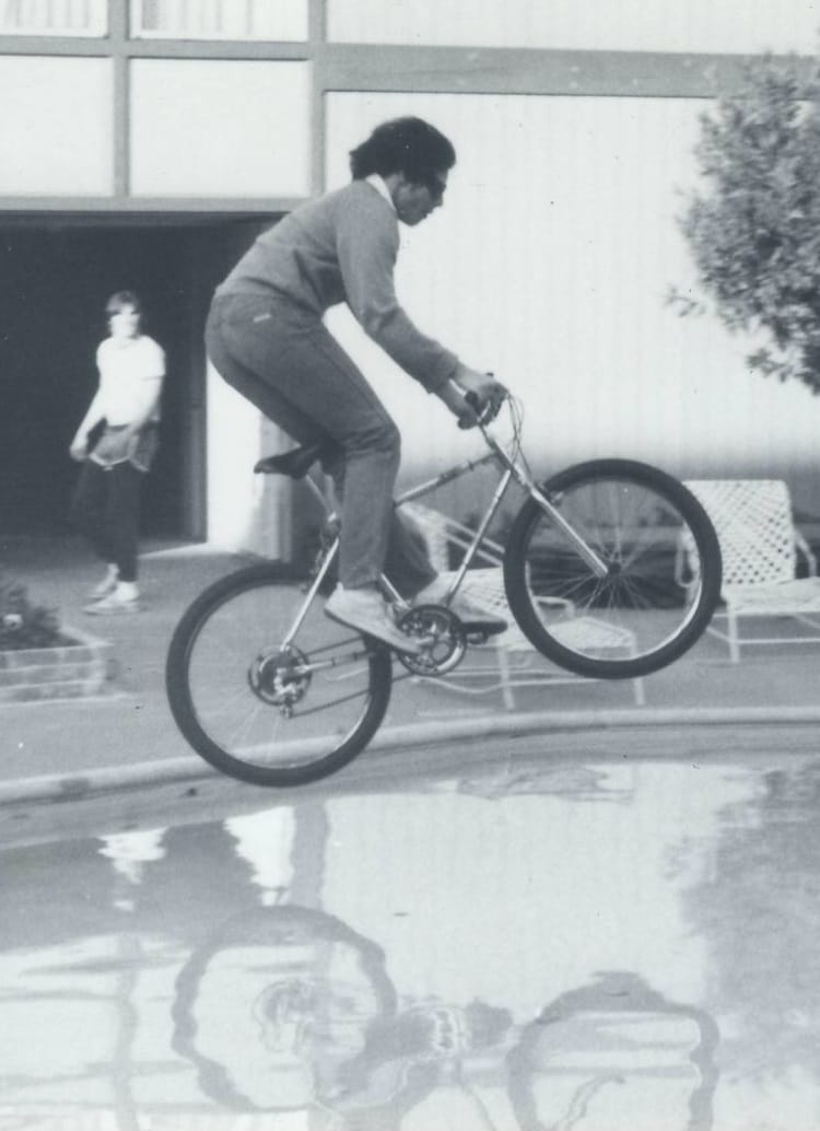Mark Nichols jumping an early mountain bike over a pool deck at Sac State in January 1982, months after the first production mountain bikes shipped